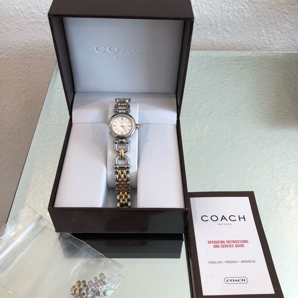 Coach signature stainless steel dual tone watch.